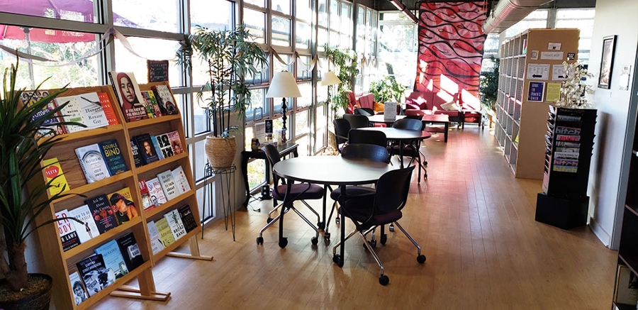 3 of 4, Women's Center - Library area with bookshelves and seating - UC San Diego